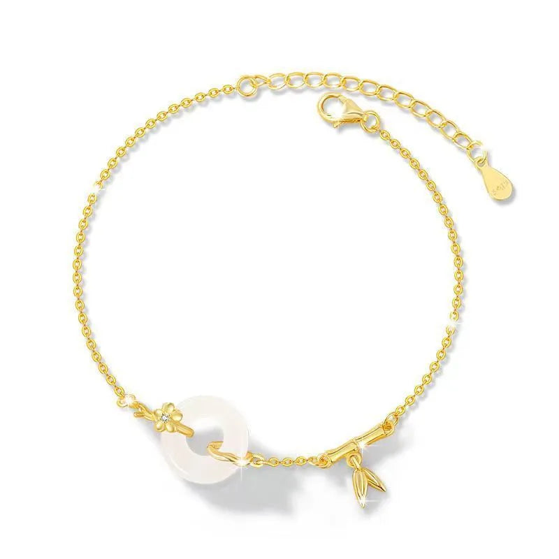 Gold tone women's bracelet with white chalcedony stone and adjustable peace symbol buckle closure