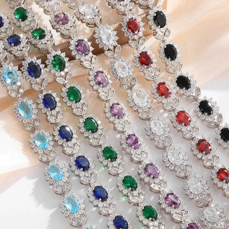 Simple electroplated alloy bracelet for women with inlaid zircon stone in one of nine colour options including ruby, emerald, and black onyx.