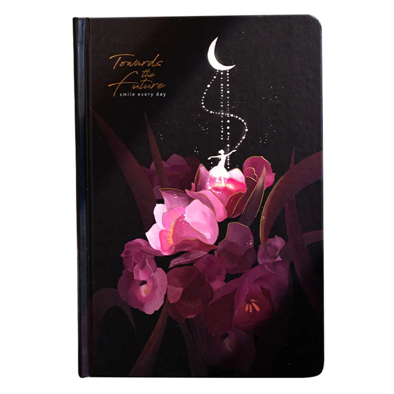 A5 notebook with a luminous cover open to show pages with colour illustrations.