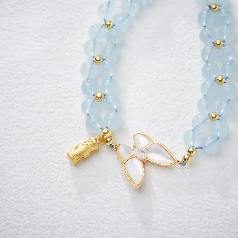 Handmade women's woven bracelet with 6mm aquamarine beads and butterfly decoration in retro style