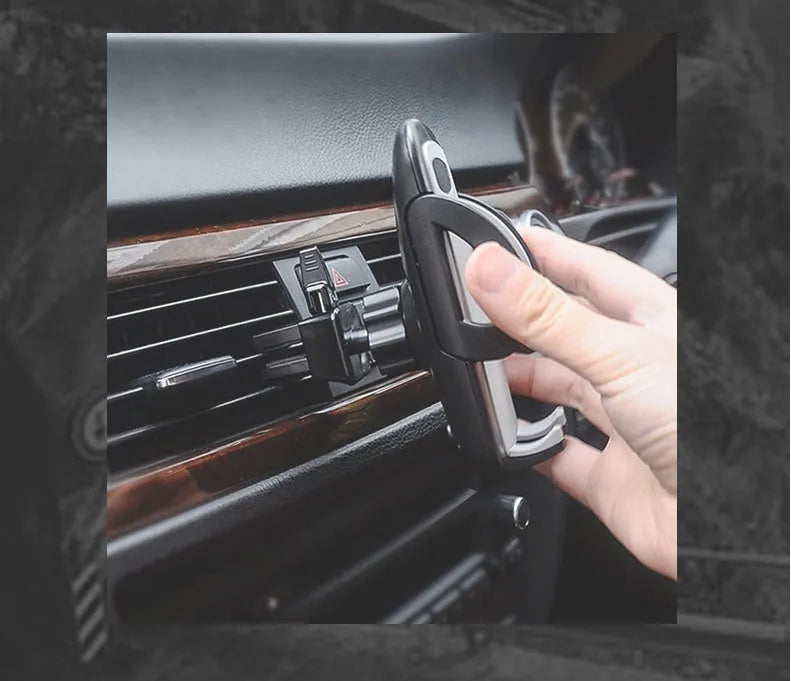 Black plastic universal car phone holder mounted on a car air vent