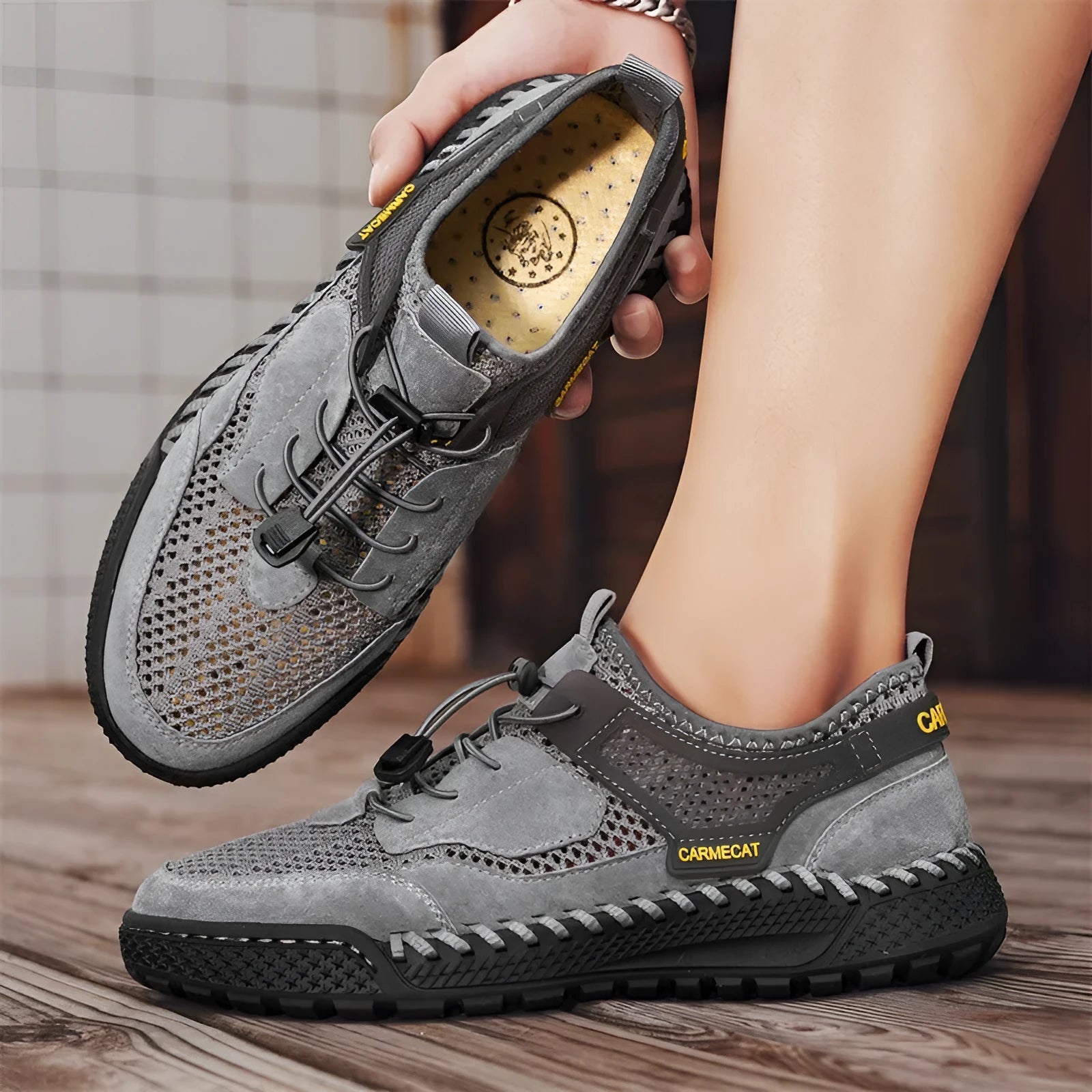 Men's brown suede tennis shoes with elastic closure and hand-stitched rubber soles