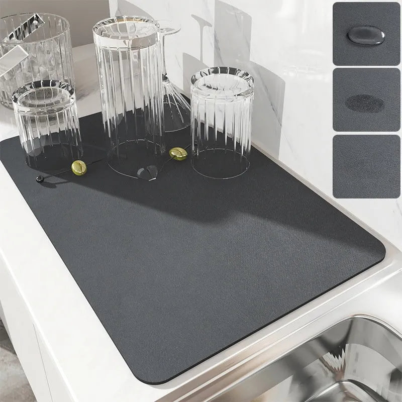 Black square rubber-backed kitchen drying mat on a countertop next to a coffee cup