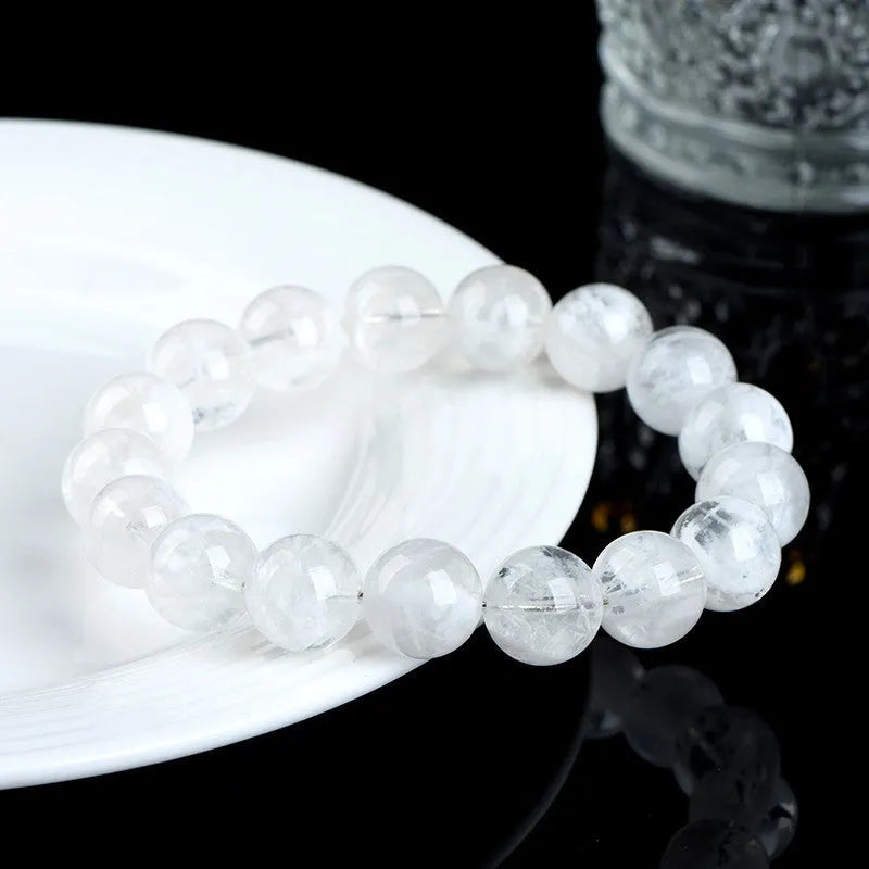 Crystal women's bracelet with natural blizzard snowflake round beads in geometric shapes showing traditional Ruyi and Xiangyun motifs