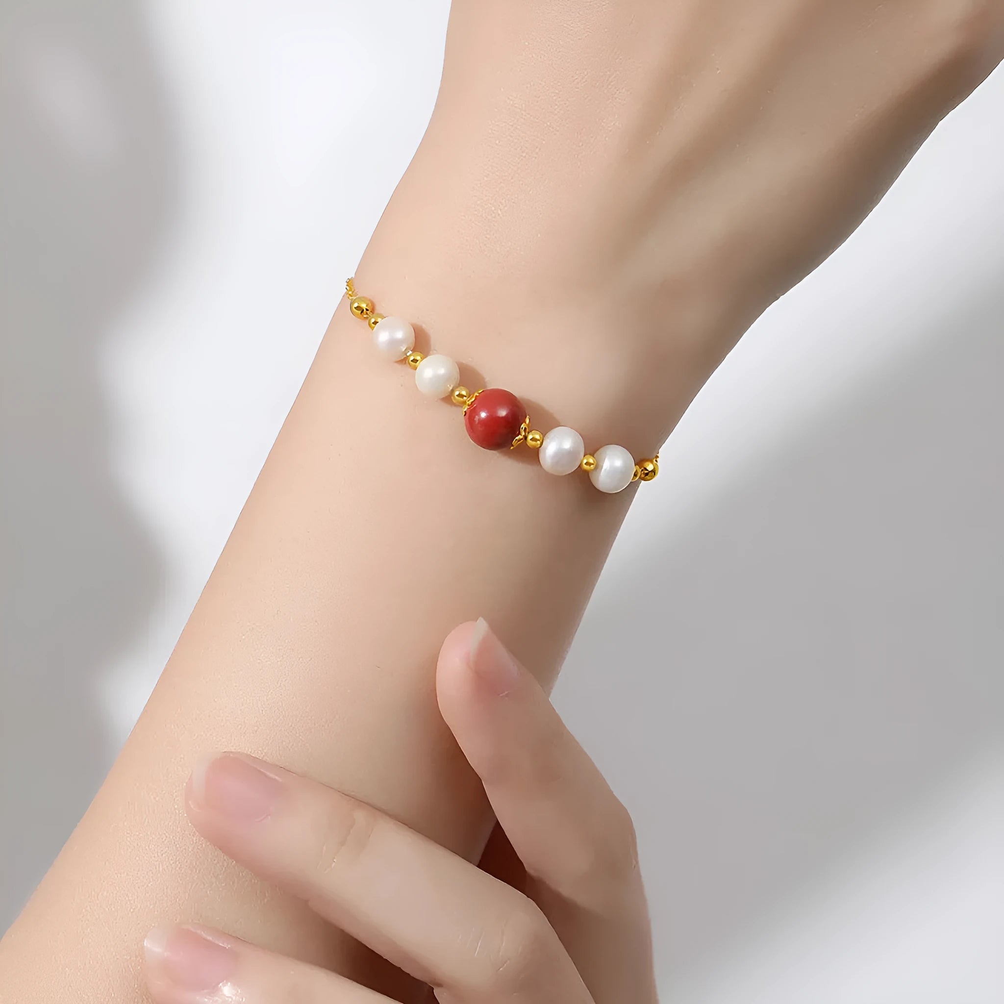 Yellow retro-style bracelet with red cinnabar beads and white pearls on a silver chain.
