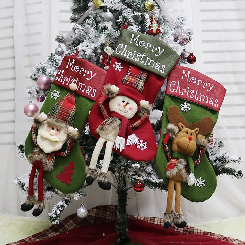 Three large Christmas stockings with Santa, Snowman and Reindeer designs hanging from a mantelpiece
