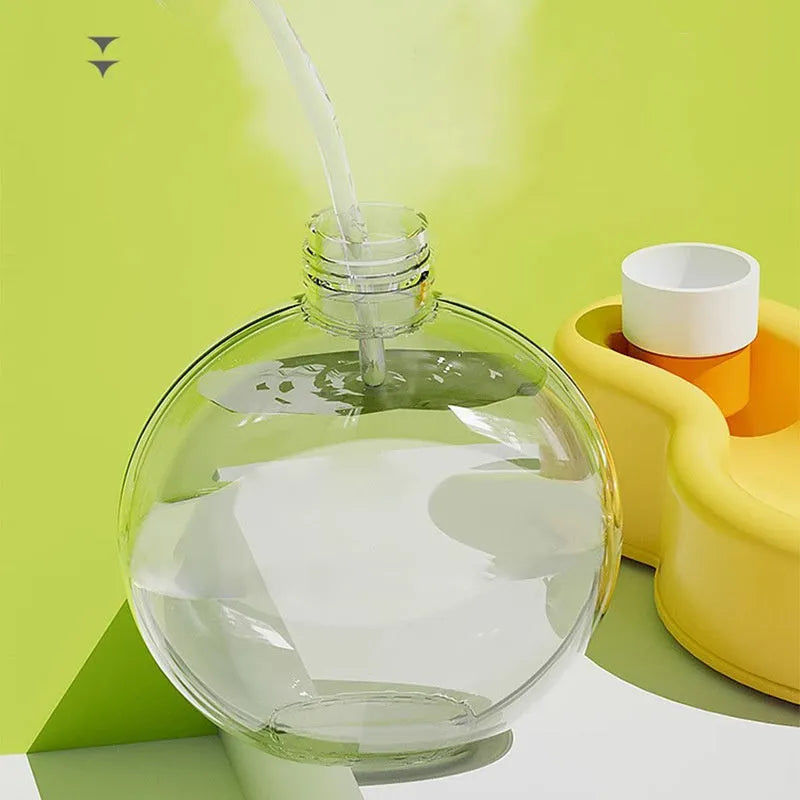 Green portable dog water bottle with pull-out drinking bowl on a table