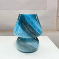 Handmade glass mushroom table lamp in Earth colour on wooden bedside table, 15cm by 19cm