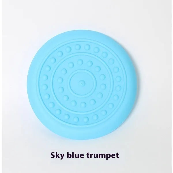 Plastic dog frisbee toy in green, shown on grass for fetch play.