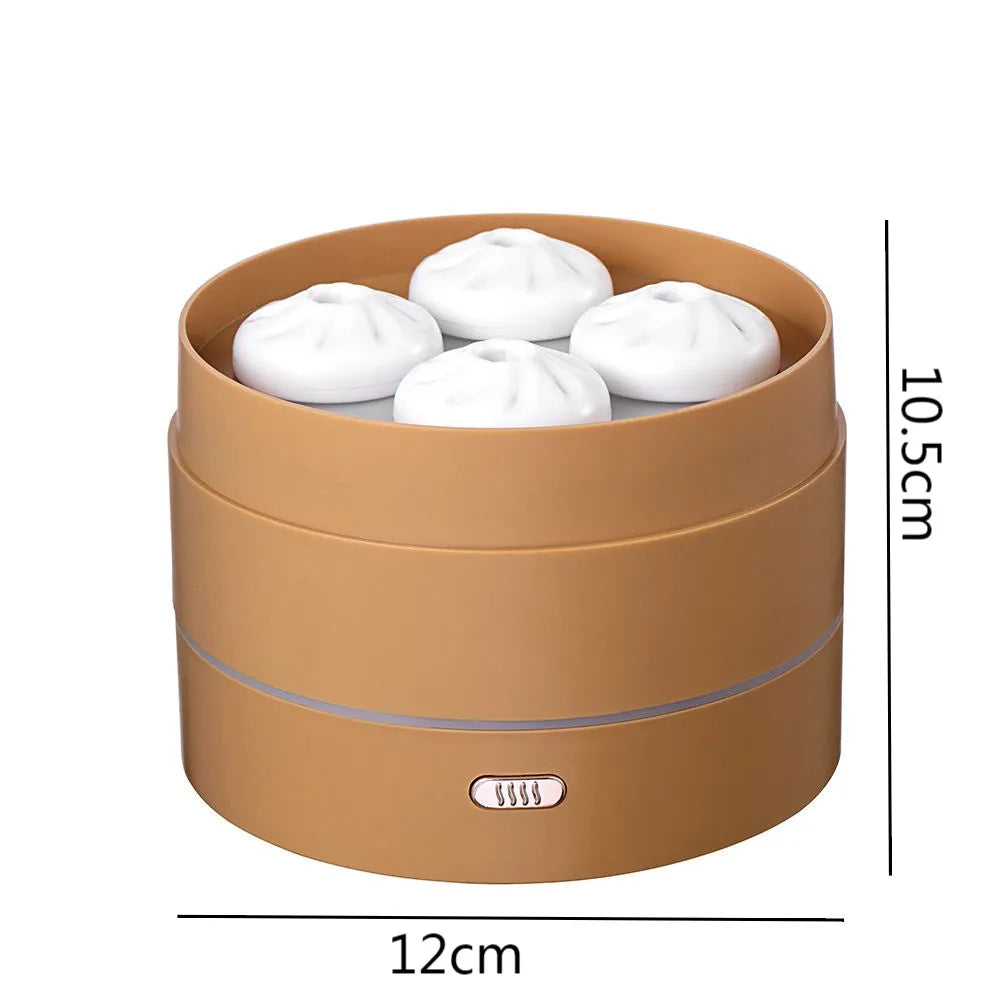 White ultrasonic aroma diffuser with four steam nozzles and LED light on a wooden table