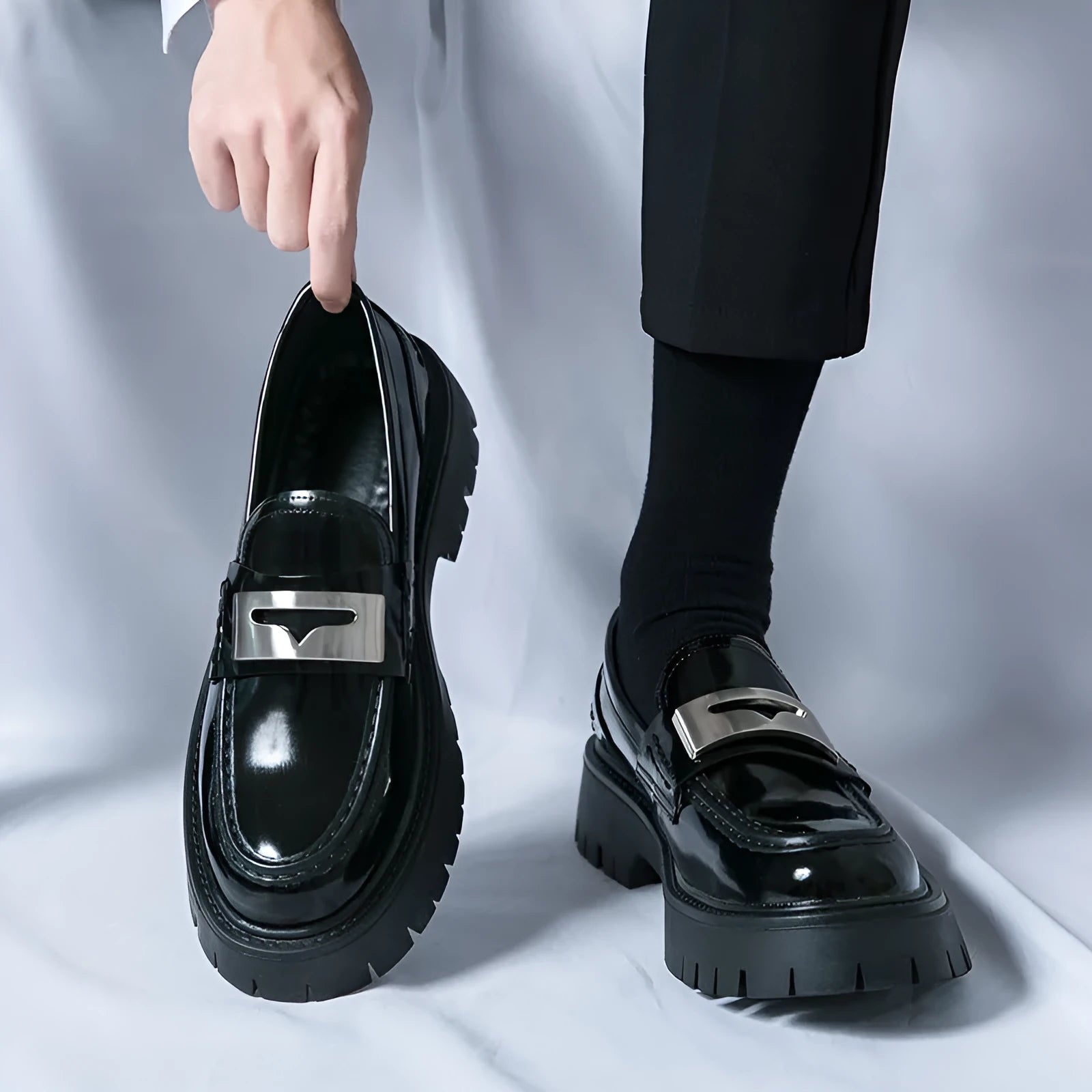 Men's glossy black PU leather loafers with a hidden low heel platform sole.