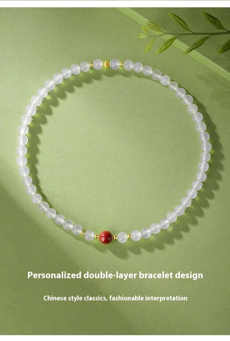 White agate women's bracelet with 6mm beads, geometric double-layer design and a jequirity bean cinnabar accent.