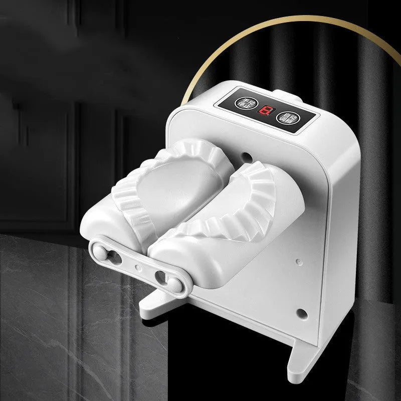 White automatic electric dumpling maker machine with USB cable and accessories on a kitchen counter.