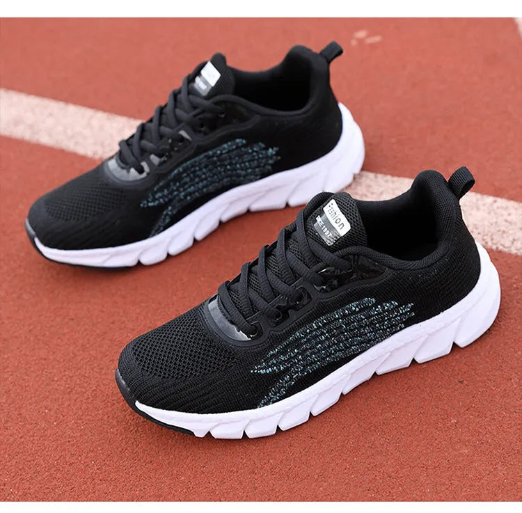Low-top black and white running sneakers with cross strap design and MD sole