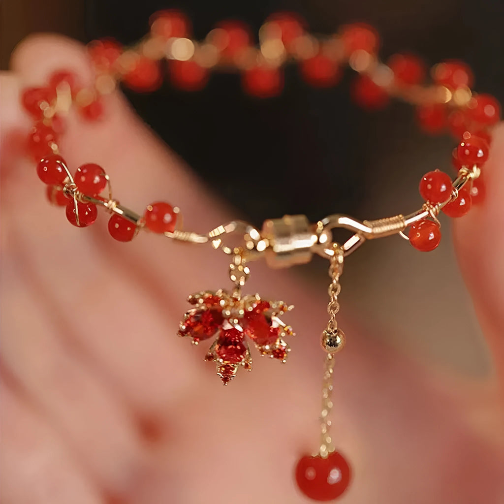 Red Chinese style magnetic bracelet with maple leaf and ginkgo leaf designs on alloy band