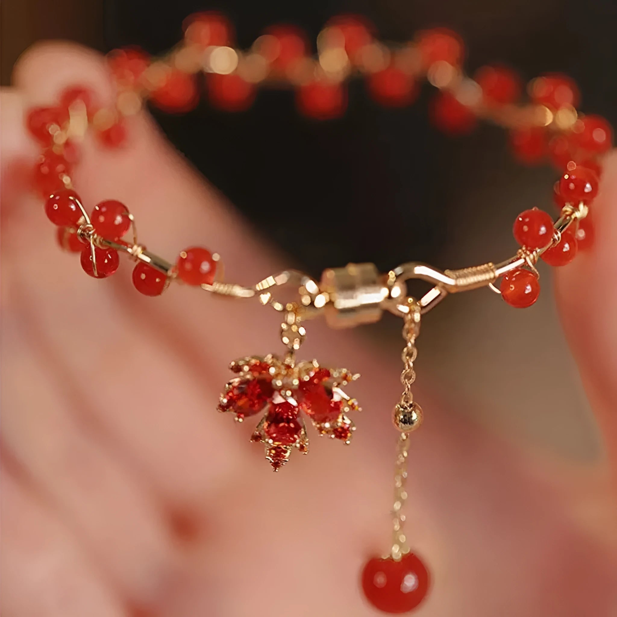 Red Chinese style magnetic bracelet with maple leaf and ginkgo leaf designs on alloy band