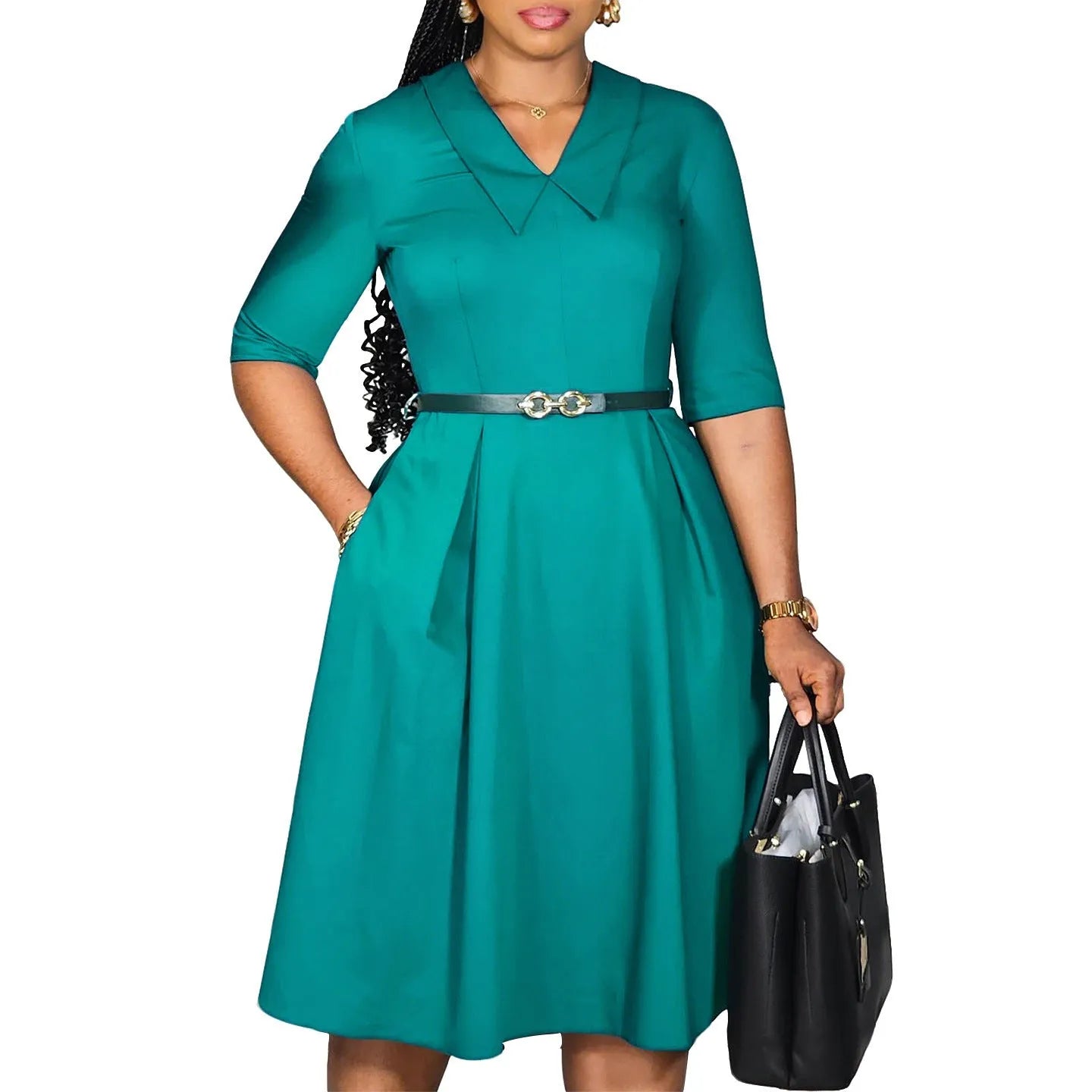 A woman wearing a solid colour African dress with half sleeves and a high waist, featuring a contrasting coloured belt.
