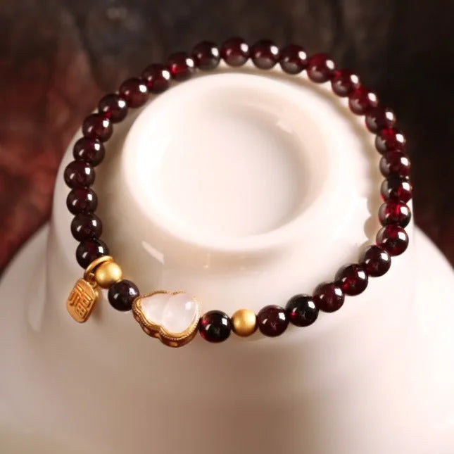 Chinese style gourd bracelet with imitation garnet beads and Fu character charms in U-shaped design