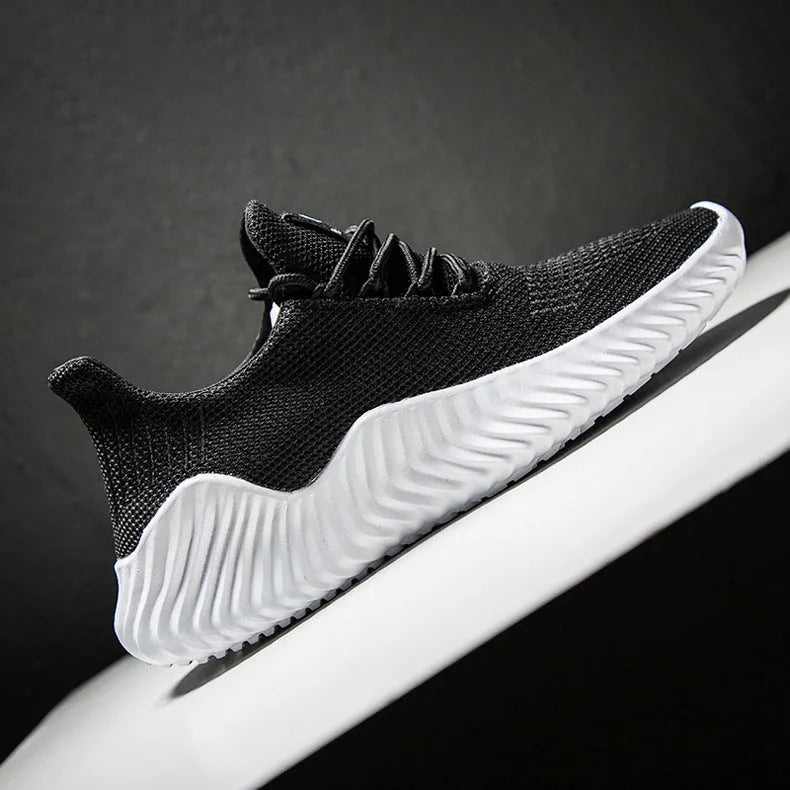 Men's breathable ultra-light running shoes with white upper and grey sole, side view