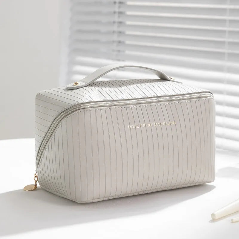 Vertical pattern pillow makeup bag in PU material measuring 22.5cm cubic for travel storage