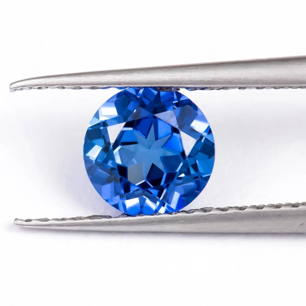 Royal blue heart shaped tiara gemstone jewellery component on white background.