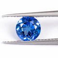 Royal blue heart shaped tiara gemstone jewellery component on white background.