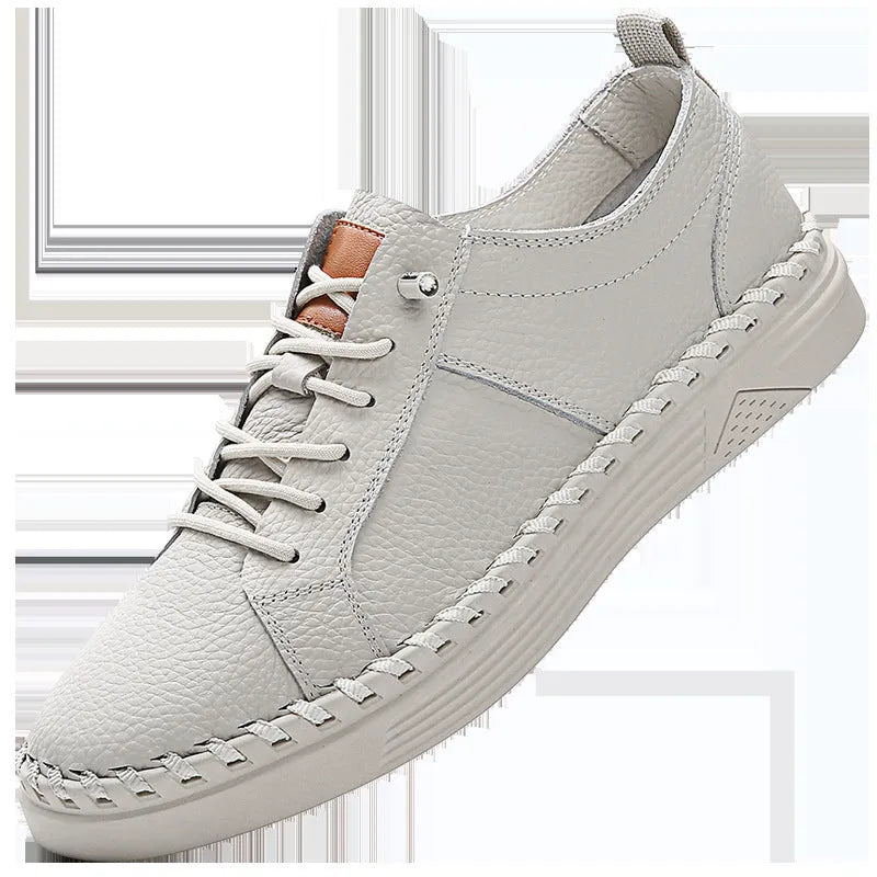 Beige and black men's round-toe cowhide sneakers with mesh lining and stitching detail.
