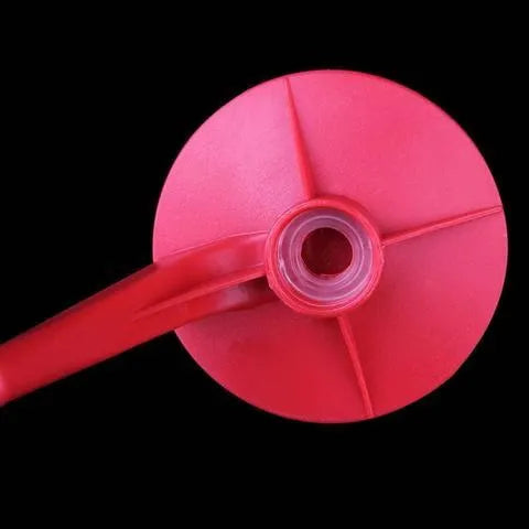 Red plastic Magic Tap soda dispenser attached to inverted 2-litre bottle for push-button drink serving