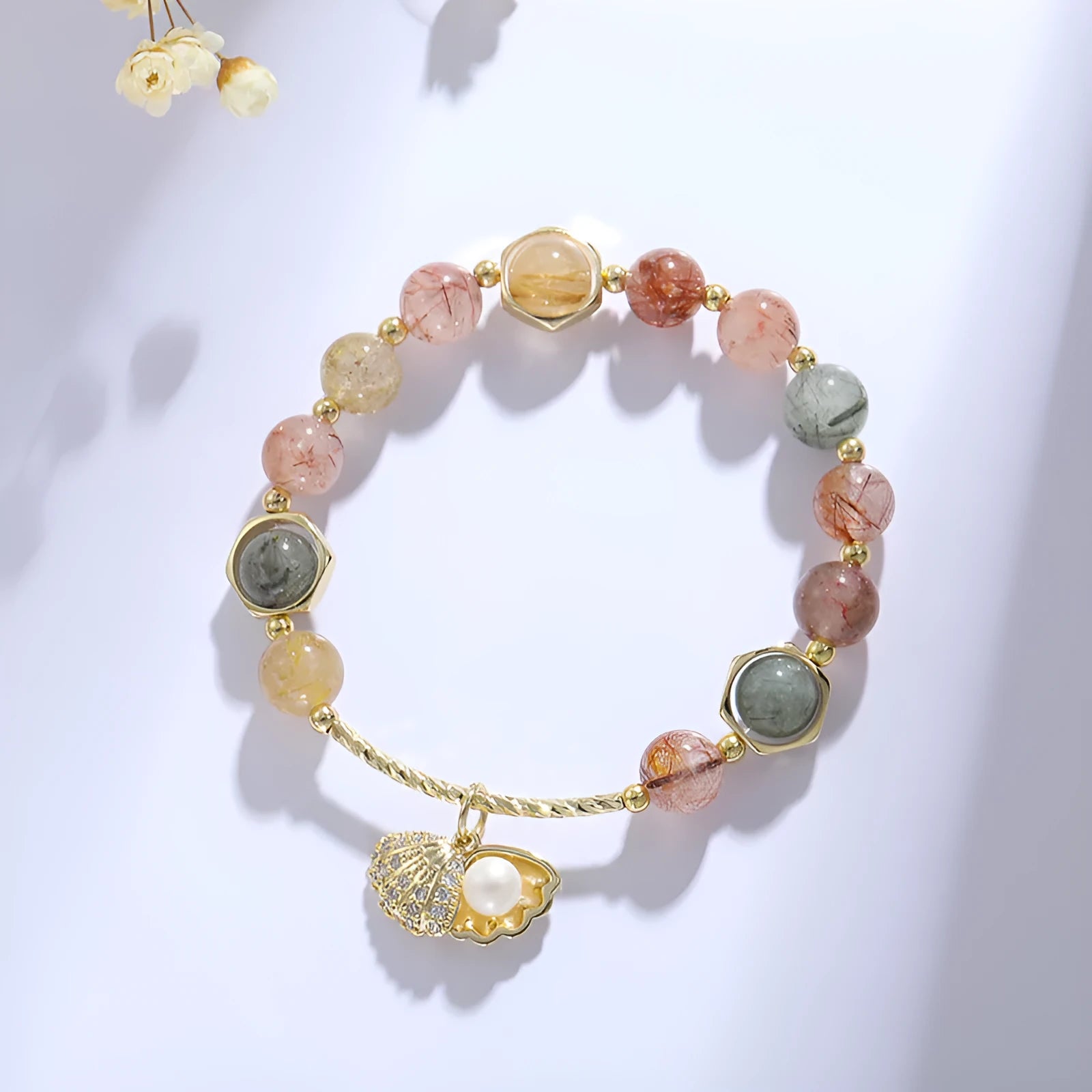 Colourful crystal shell bracelet with red sealant flower designs and animal zodiac motifs