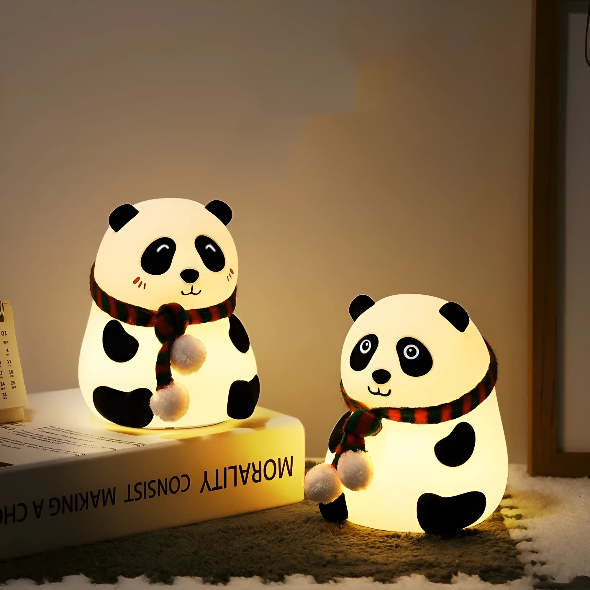 Panda-shaped silicone night light with USB cable on a table.