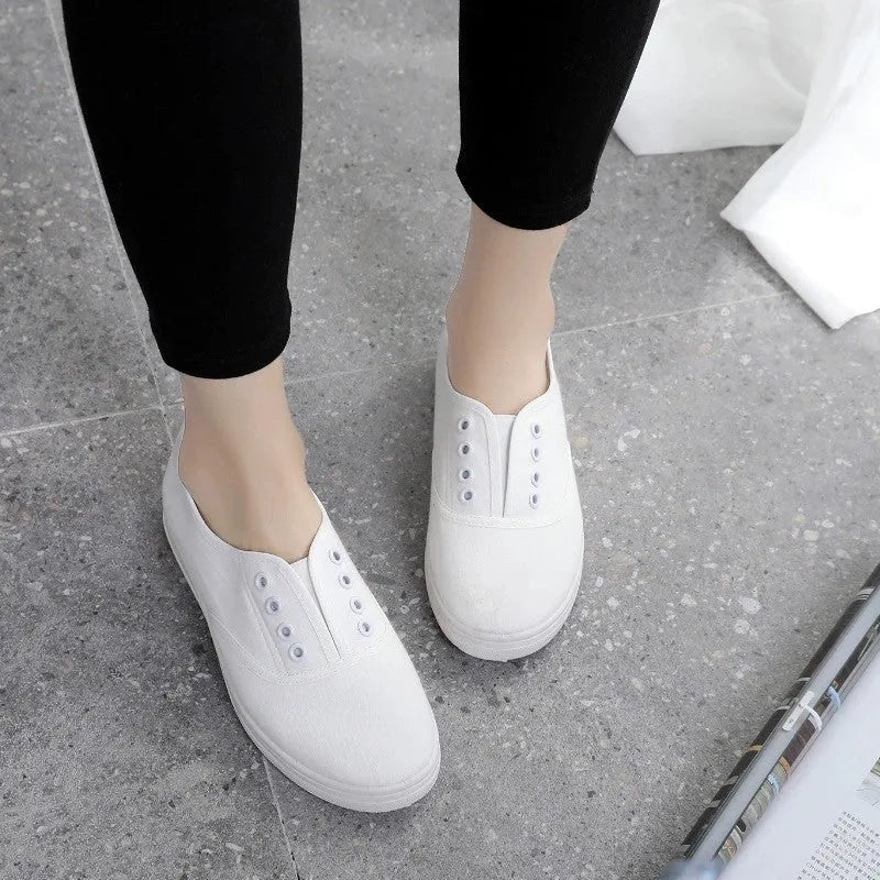 A pair of low-top canvas casual shoes in black with a flat plastic sole