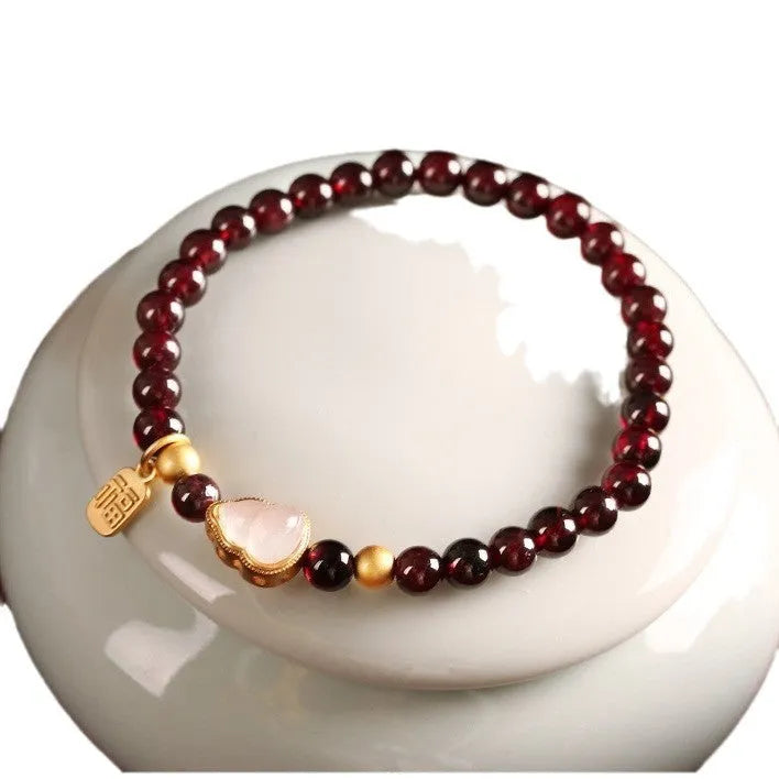 Chinese style gourd bracelet with imitation garnet beads and Fu character charms in U-shaped design