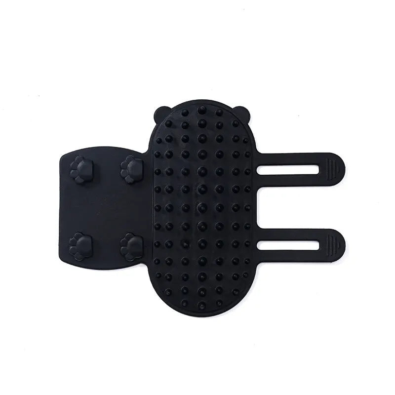 Silicone cat grooming comb with adjustable strap mounted on a table leg.