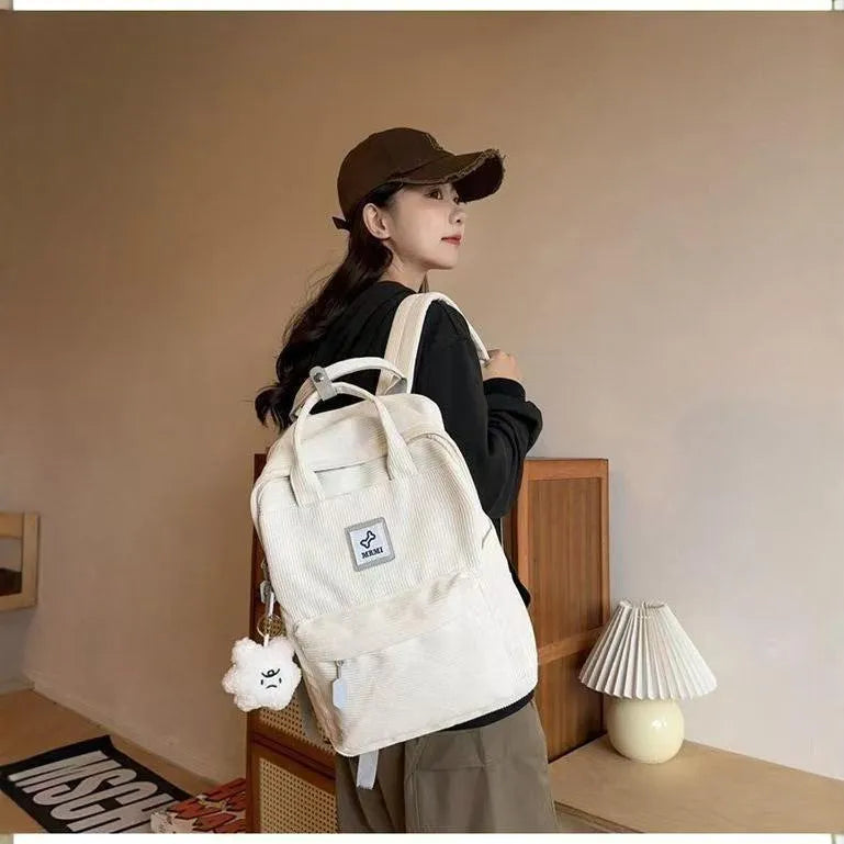 Retro hand-carrying backpack in light pink with breathable fabric, document pocket, and sewing line details for school use.