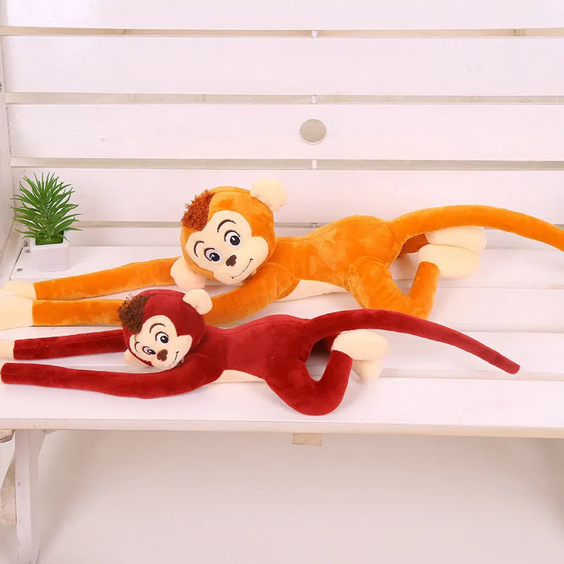 Long arm hanging monkey plush toy decoration in pink colour draped over curtain pole