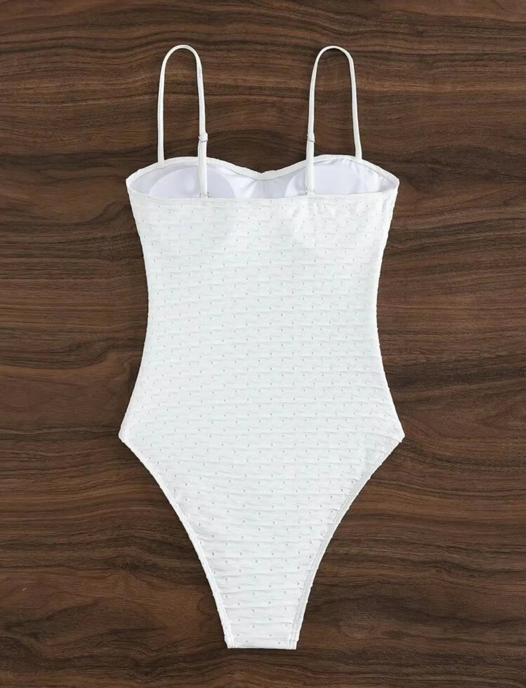 White women's one-piece swimsuit with sling style and brief cut design on mannequin