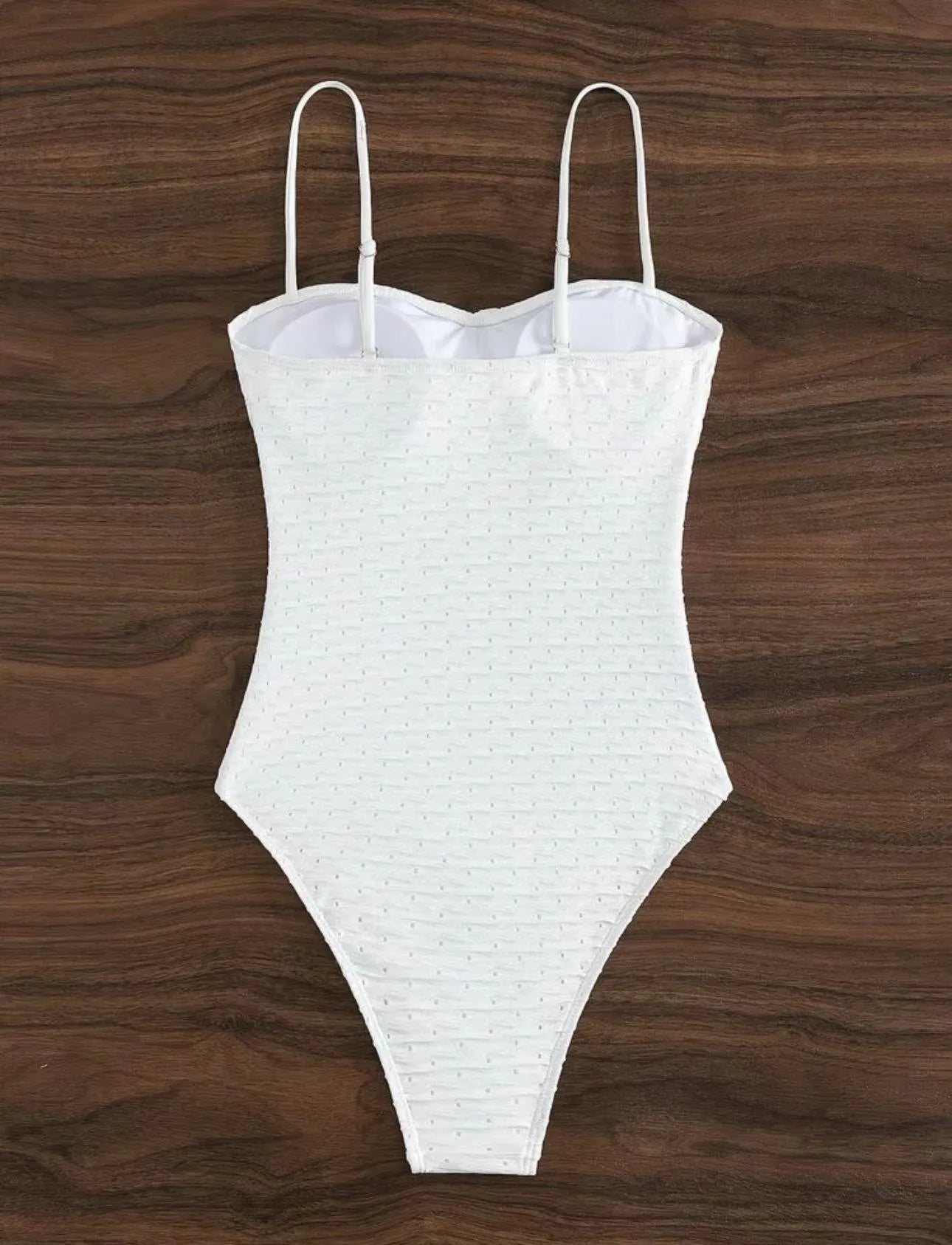 White women's one-piece swimsuit with sling style and brief cut design on mannequin