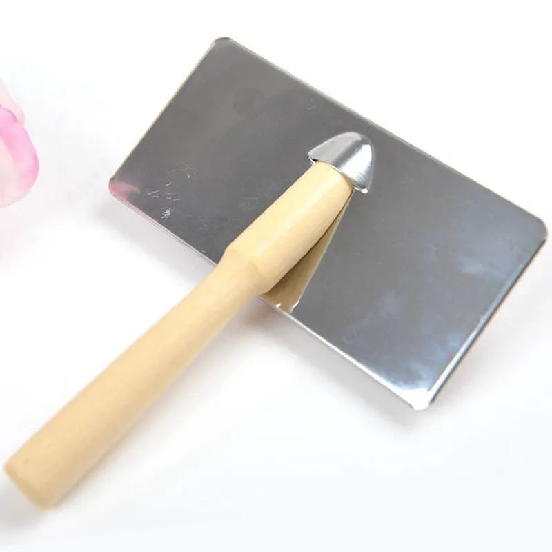 Red pet needle comb dog grooming comb with wooden handle and stainless steel plate on a neutral background
