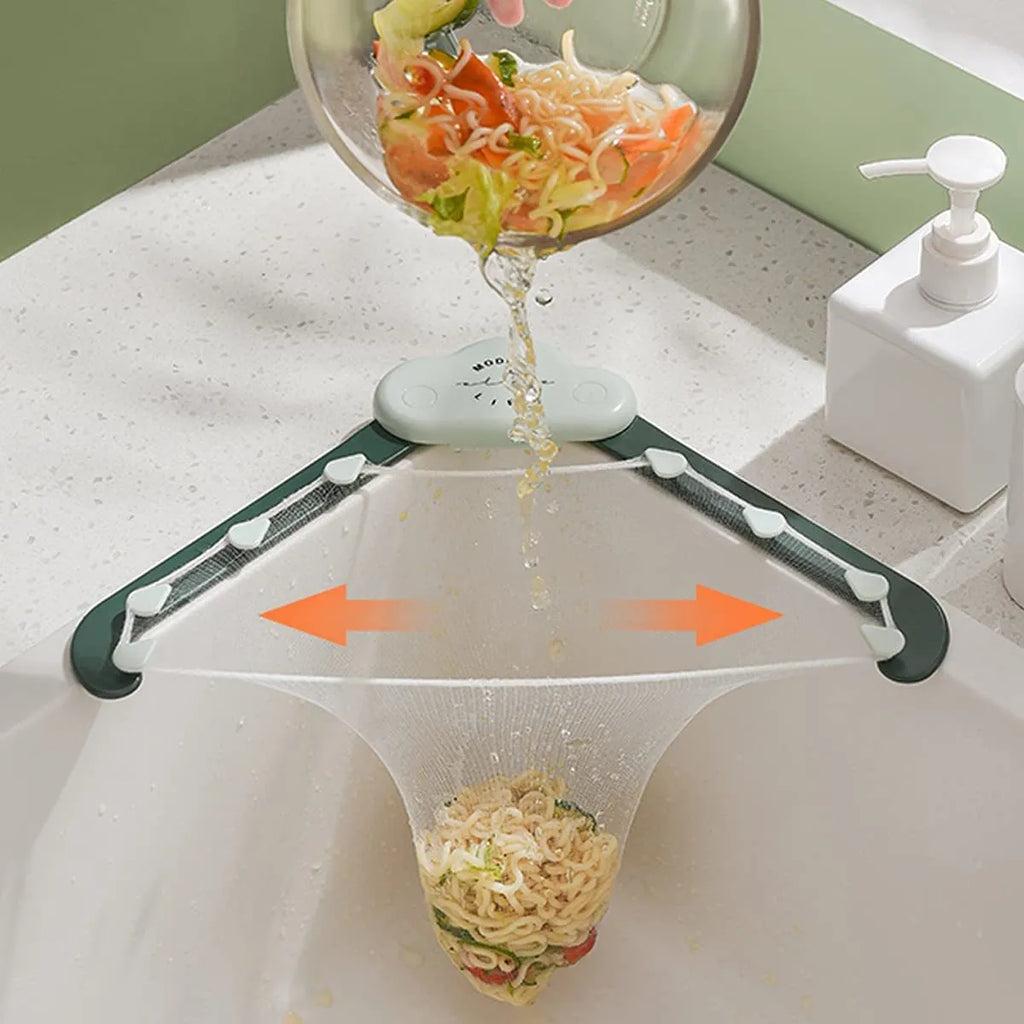 Green triangular ABS plastic sink drain rack with elastic mesh filter net installed in kitchen sink corner.