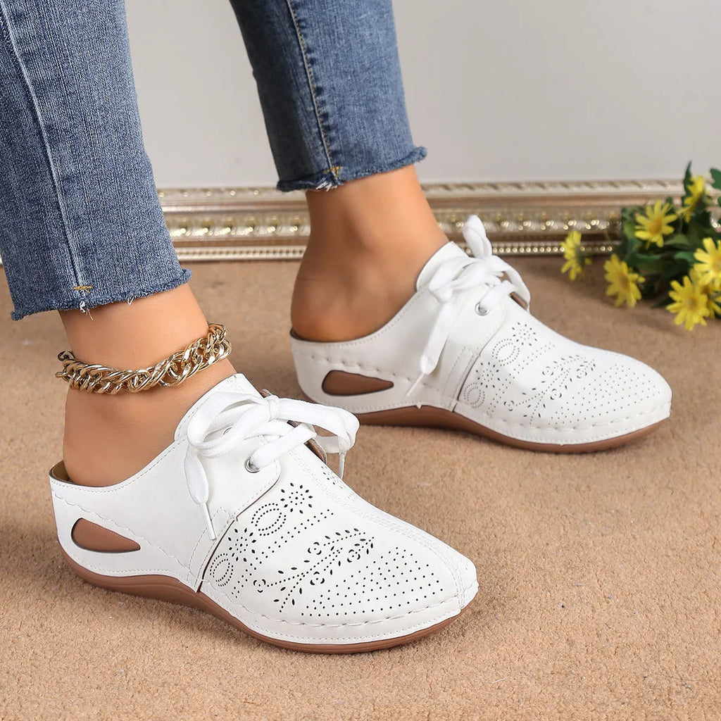 Women's suede lace-up wedge slippers in light grey with a hollow out design and rubber sole.