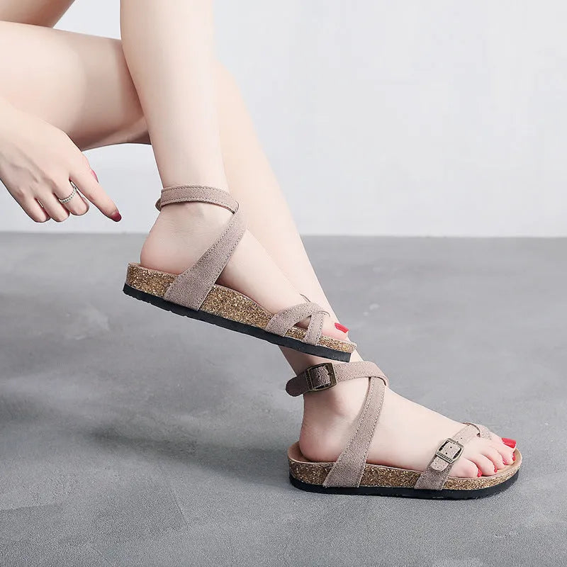 Women's cow suede toe covering slippers with buckle closure, brown colour, low heel 1-3cm, round toe, flat heel on plain background
