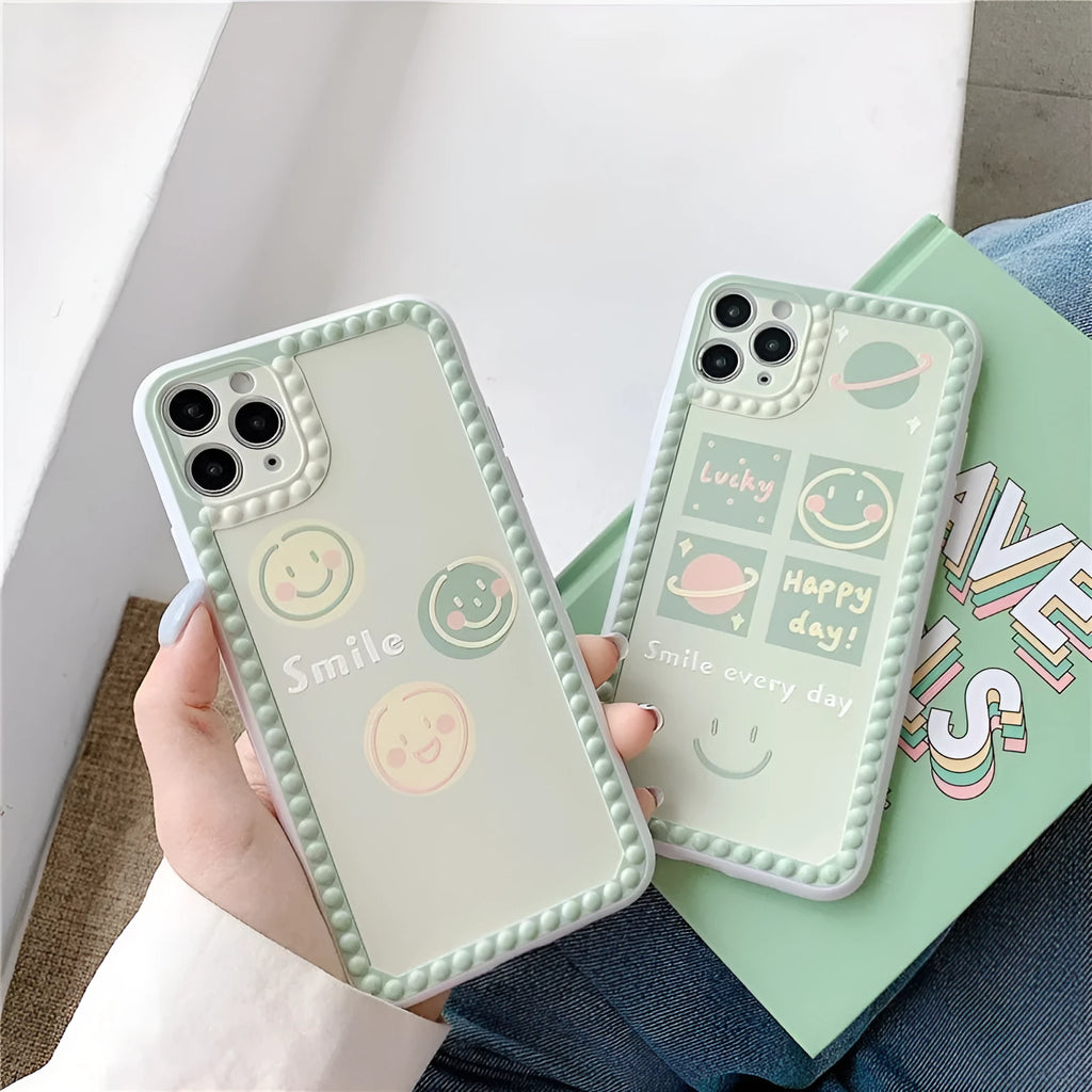Green soft TPU iPhone case with geometric smiley face and polka dot frame design.
