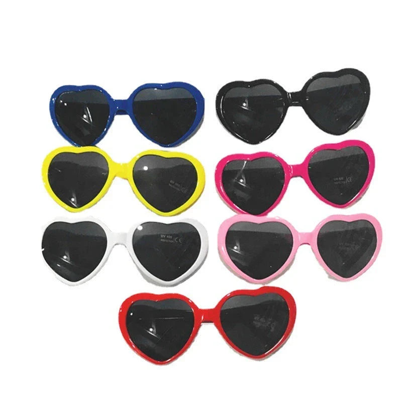 Heart-shaped glow-in-the-dark sunglasses in various vibrant colors, featuring a durable plastic frame and resin lenses for reliable UV protection.