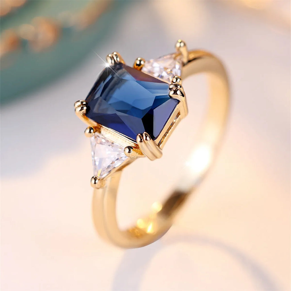 Rectangular copper ring with gold sapphire blue finish for women, shown in size options 6 to 13