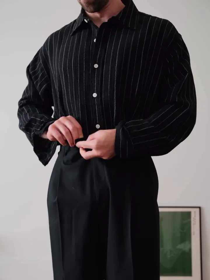 Men's black pinstriped button-down polyester shirt with long sleeves and a regular fit.
