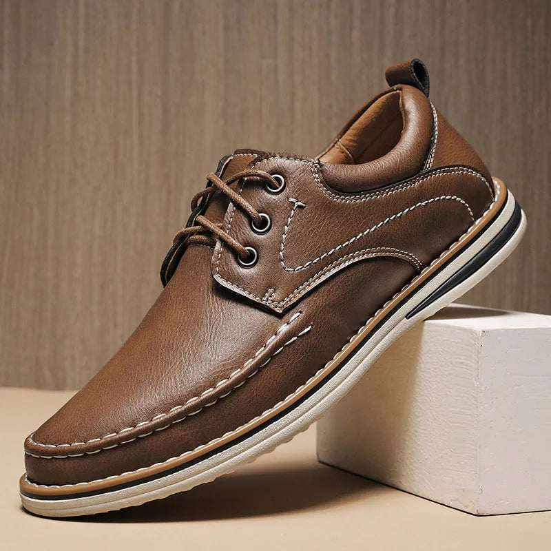 Men's black genuine leather lace-up casual shoes with round toe and low rubber sole on a white background.