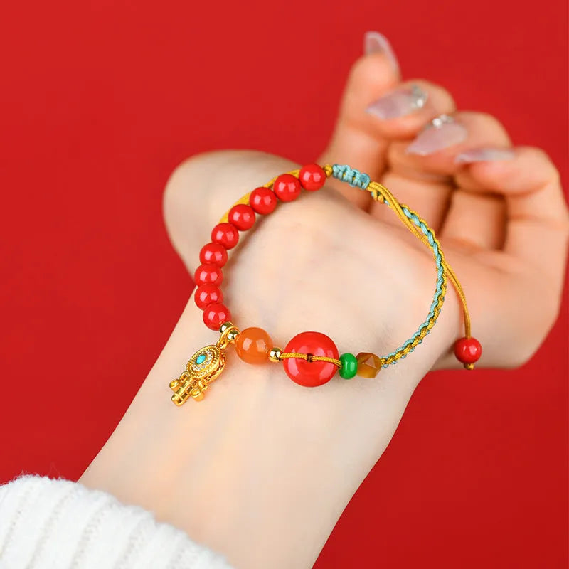 Hand-woven cinnabar peace blessing bracelet in emperor red sand colour with geometric national style design