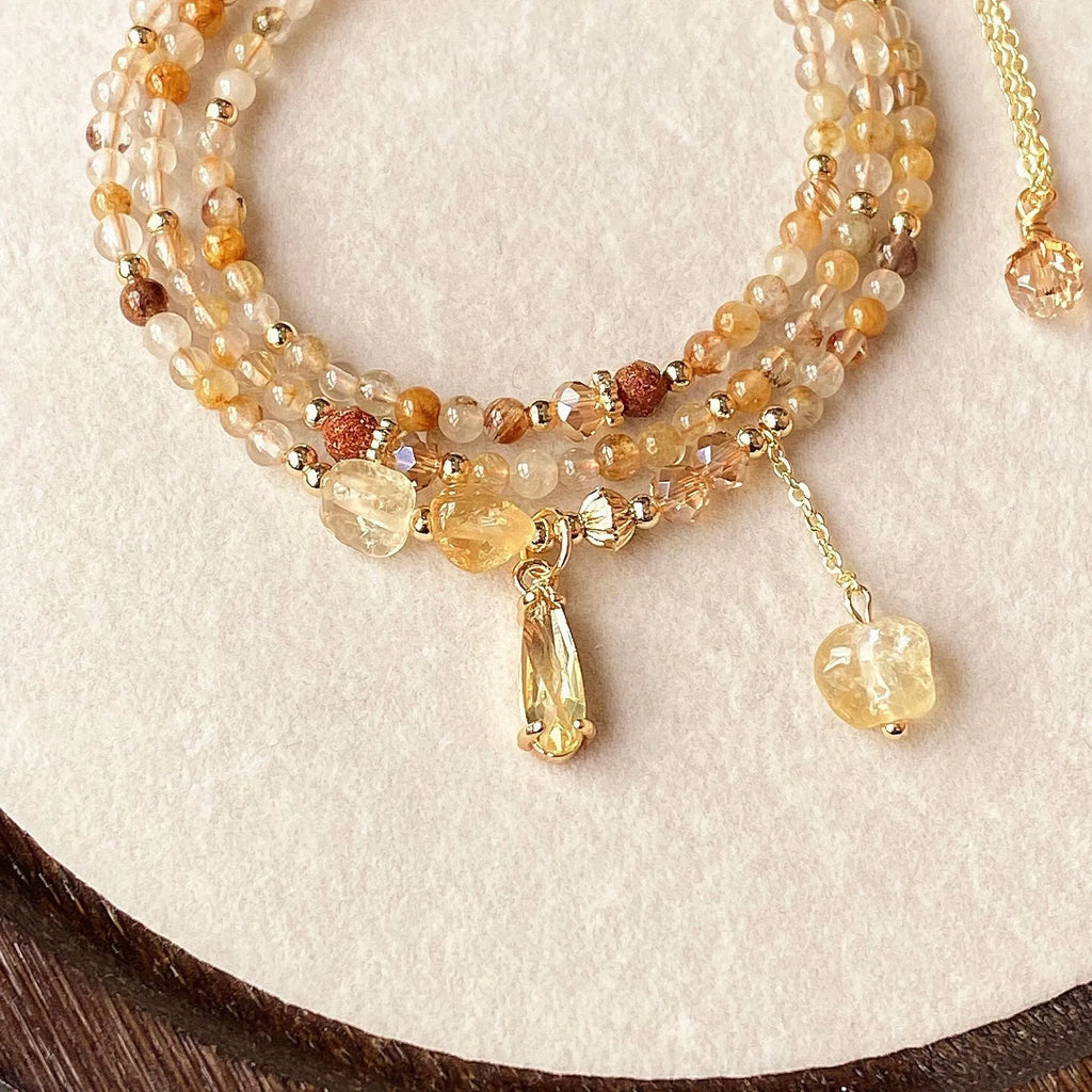 Women's natural citrine crystal bracelet with caramel layers and Saturn ring charm in gold finish