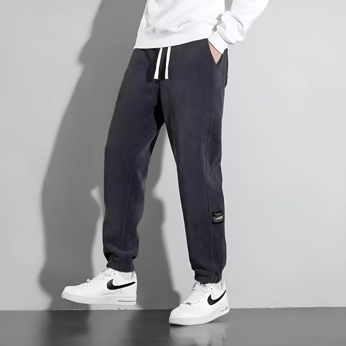 Men's loose straight drapey sweatpants in dark gray with drawstring waist and cotton blend fabric