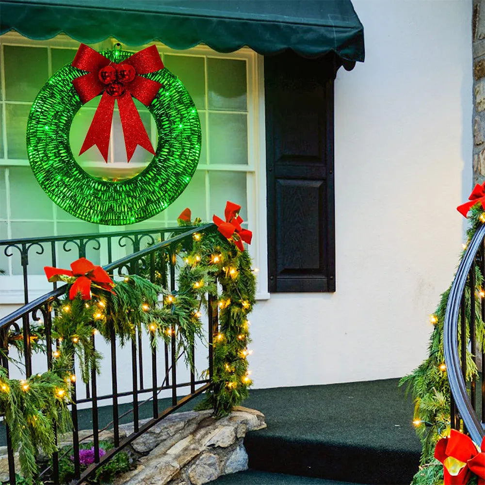 50cm gold green tinsel Christmas garland with LED lights and big bowknot on a wooden door